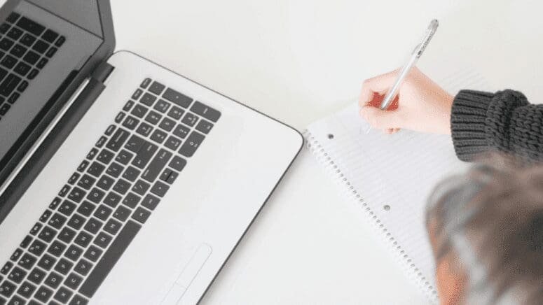 A woman making a checklist for selling the house